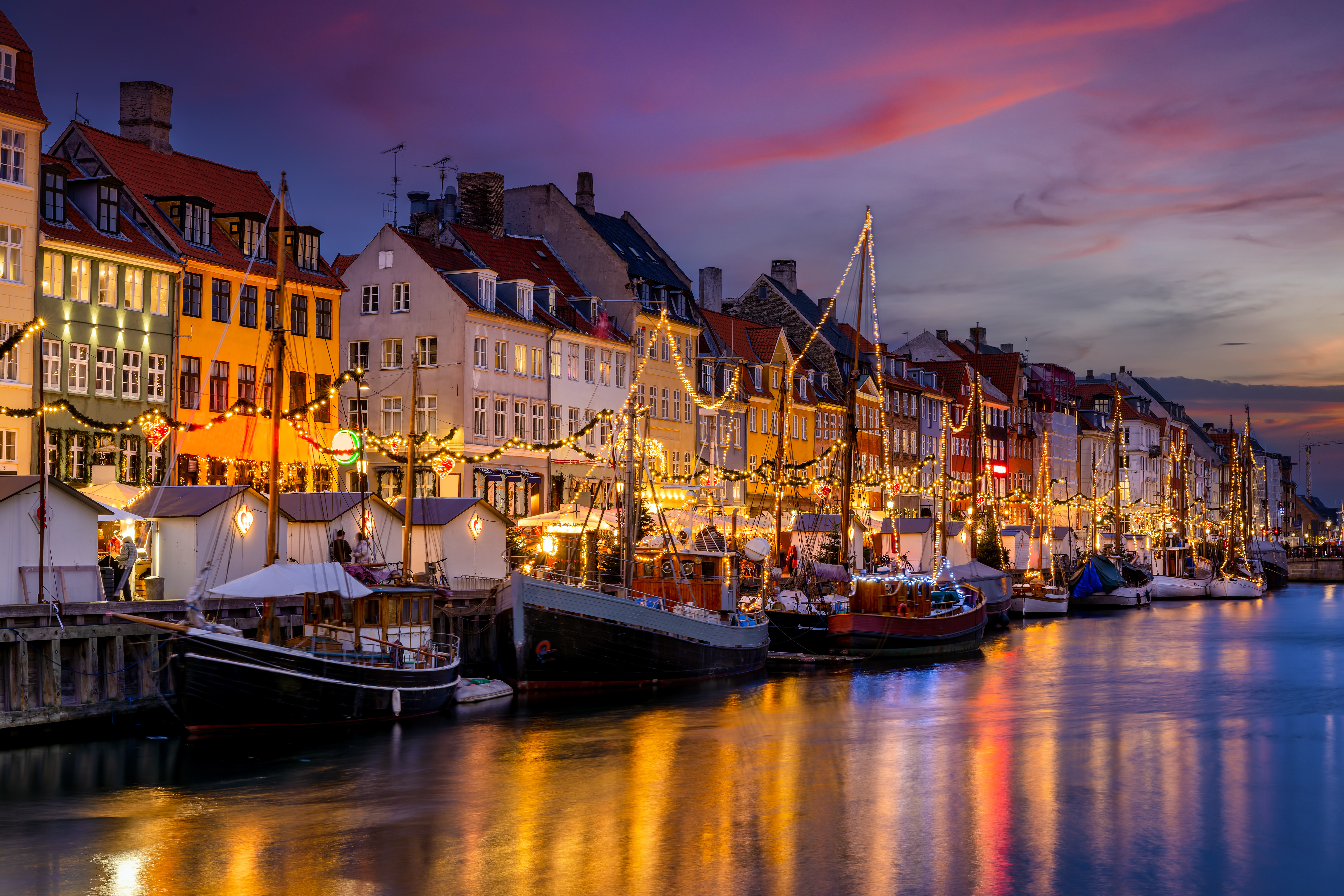 Beautiful winter sunset view of the popular Nyhavn area at Copenhagen, Denmark, decorated for Christmas