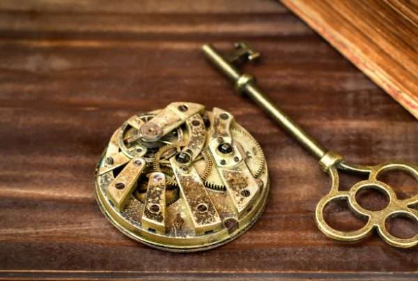 Key and clockwork on a wooden background, escape room game banner
